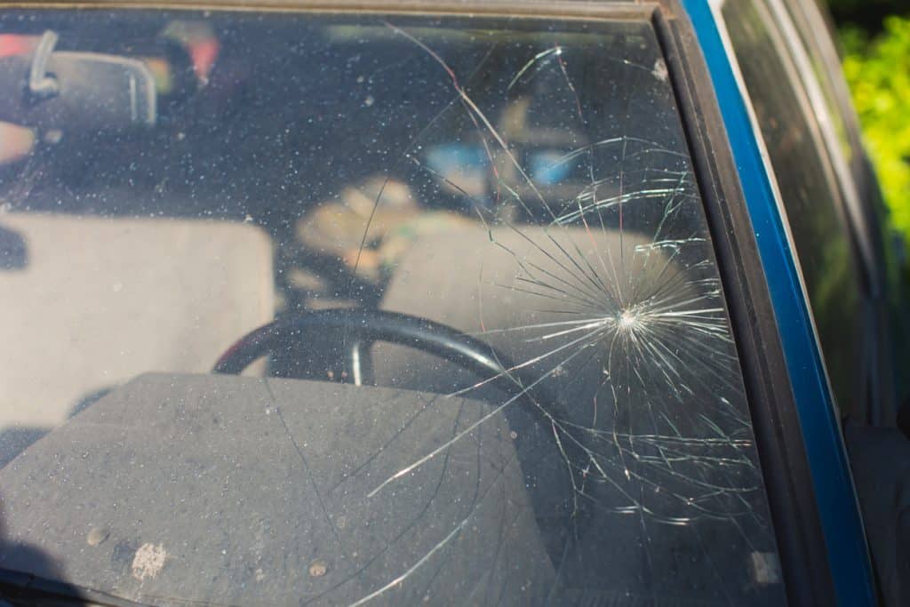 Old abandoned car. Broken windshield with cracks