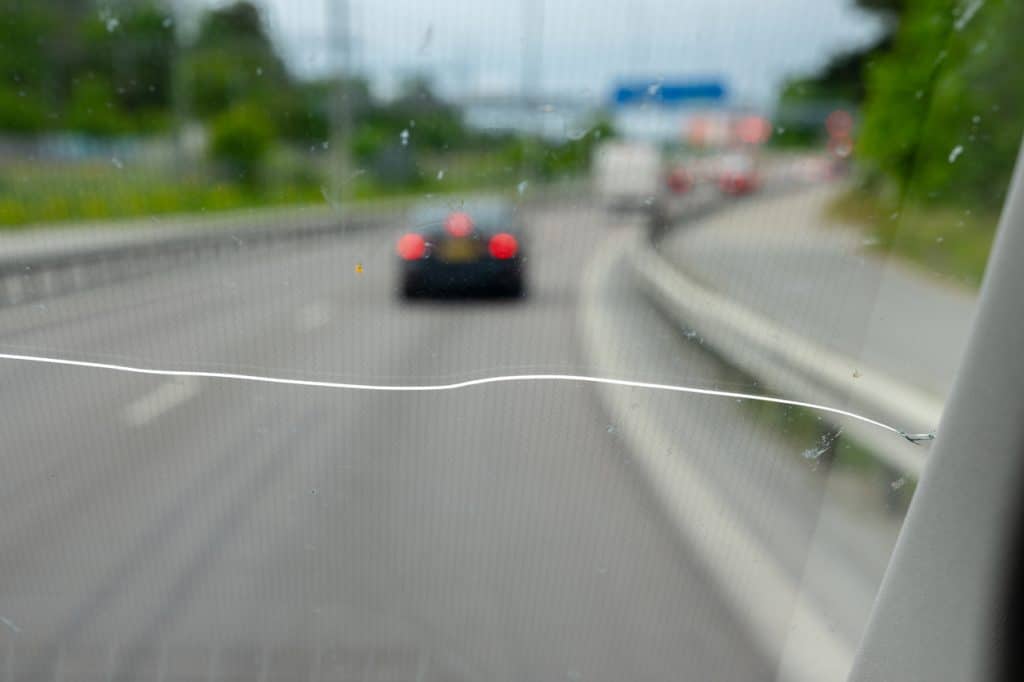 Cracked Windshield View on a Highway